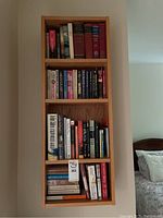 Full bookshelf filled with various books of different authors and titles.