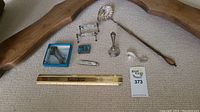 Overhead view of all items laid out with wooden frame segments and ruler