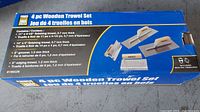 Box showing the set contents and specifications of 4 wooden trowels