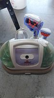 Front view of the Bissell Little Green Turbo Brush portable carpet cleaner with hose and brush attachments.