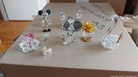 Overview of all crystal figurines on display including swan, flower, and animal figures.