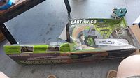 Photo of the Earthwise chainsaw box and packaging laid out on the floor showing box branding and packaging materials.