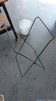 Folding steel garbage bag stand upright showing the full frame structure