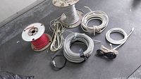 Full overview of assorted wires and cables including multiple spools and various colors and types of wiring.