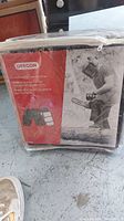 Photo of packaged Oregon Protective Apron Chainsaw Chaps with label showing brand and product name in multiple languages.