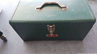 Front view of the vintage green Park steel tool box showing handle and latch.