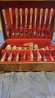Overall view of silverware set in wooden box showing forks and spoons