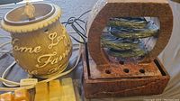 Wax warmer and relaxation water fountain side by side on table surface.