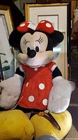 Stuffed Minnie Mouse plush doll in classic red and white polka dot dress and bow, showing detailed condition and size.