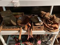 Shelf with vintage scale, wooden art bowl, thread spools, and rolled burlap fabric