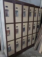 Front view of 18-compartment steel locker bank with closed doors