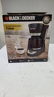 Box showing the Black & Decker programmable 12-cup coffee maker with timer functionality and brand logo