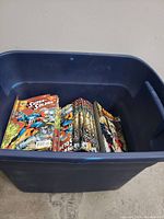 Blue plastic bin containing a large stack of Super Soldier comic books.