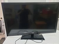 Front view of the black Toshiba 48 inch flat-screen TV showing screen and stand.