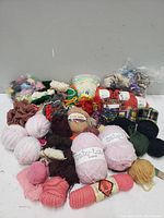 Full spread of assorted yarns in different colors and styles arranged on a flat surface.