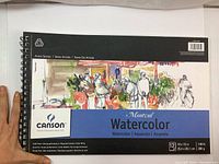 Front cover of the Canson Montreal Watercolor sketch book showing title, brand, and artwork.