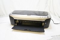 Front view of EPSON Stylus Photo 2200 printer with input and output trays visible, buttons on top right