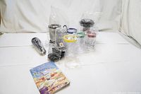 Full set of Magic Bullet blender and accessories arranged on white backdrop.