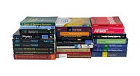 Wide-angle photo showing three stacks of college engineering and physics books including titles about quantum mechanics, advanced physics, and continuous matter.