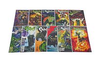 14 The Spectre comic books displayed on a white surface in two rows. Comics are bagged and boarded, featuring diverse cover art with supernatural and heroic imagery.