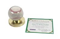 Front view of autographed baseball in display case with certificate of authenticity and gold-toned display stand.