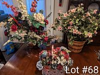 Photo showing all three floral arrangements on a wooden table in a living room environment.