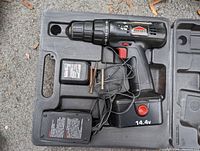 Jobmate 14.4V cordless drill packed with battery, charger, two drill bits, and bit holders inside molded plastic carrying case