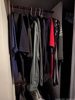 Photo of hanging men's shirts in assorted colors and styles including polos and button-downs.