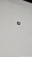 Clear photo of the 1.07ct natural Brazilian aquamarine cushion cut gemstone on a plain background to show color and cut.