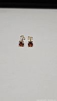 Pair of Madeira citrine earrings showing front view and color detail.