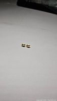 Pair of natural citrine oval cut gemstones shown on white background, small size visible.
