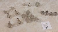 Full view of the 15 antique glass dresser pulls assorted including knobs and handles.