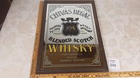 Full view of framed Chivas Regal mirror with ruler showing dimensions