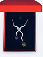 Red LED light display box open showing necklace inside