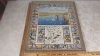 Full view of the framed 'Godfrey Wildfowl Pictorial' print showing the central wildlife artwork surrounded by bordered wildfowl illustrations with a wooden ruler for scale.