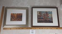 Two framed prints displayed side by side with ruler for size reference, showing autumn forest scenes.