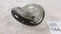 Top angle view showing smooth, rounded organic shape and cigarette rest notch.