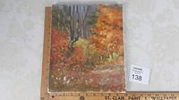 View of the full 12 x 10 inch oil painting on canvas depicting fall landscape with autumn colored foliage and bare trees, unframed.