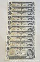 Ten consecutive 1973 Canadian one dollar bills stacked front side up showing sequential serial numbers.