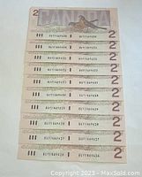 Ten sequential 1986 Canadian $2 bills showing back side with serial numbers from BUY146926 to BUY146935