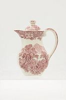 Front view of the antique ceramic pitcher with floral and landscape red transferware pattern, showing shape, spout, handle, and lid.