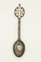 Front view of antique silver spoon with 'IN HOC SIGNO VINCES' inscription on handle top and ornate handle design