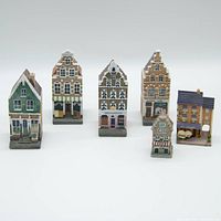 Front view of the 6 vintage decorative model houses arranged in a row, showing their colors and architectural details.