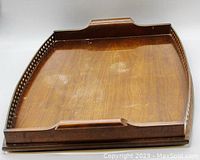Top view of the large antique wooden serving tray showing carved sides, raised edges, and integrated handles.