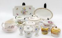 Photo showing a variety of vintage ceramic items including dishes, cups, and containers with floral, scenic and bird designs.