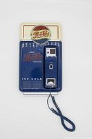 Front view of the novelty Pepsi phone showing vending machine design, logo, and handset.