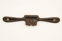 Front view of vintage Stanley spoke shave showing wooden handles and metal body with blade.