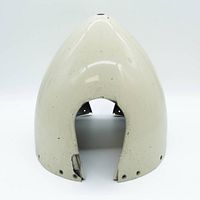 Cream-colored exterior of the vintage aircraft propeller nose cone showing front curved aerodynamic shape and mounting holes at the base.