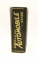 Spine of the vintage 'Audels New Automobile Guide' book showing gold embossed title.