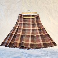 Front view of the vintage wool plaid kilt showing the pleat details and button closures on the side.